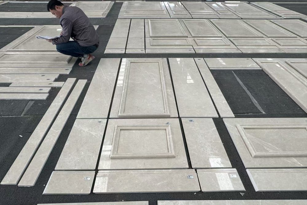 Thunder Beige marble panels laid out and checked against the cutting list