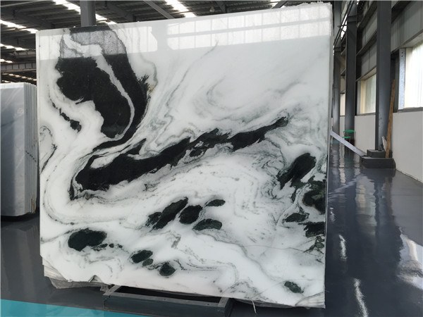 A full marble slab face, 196 by 175cm, with sparse open veining on a white ground