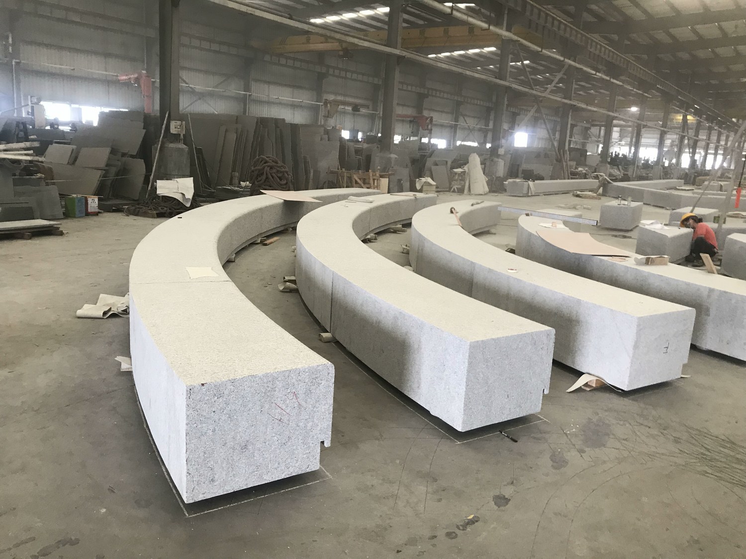 Curved California Gold granite bench sections from Brazil with a textured finish