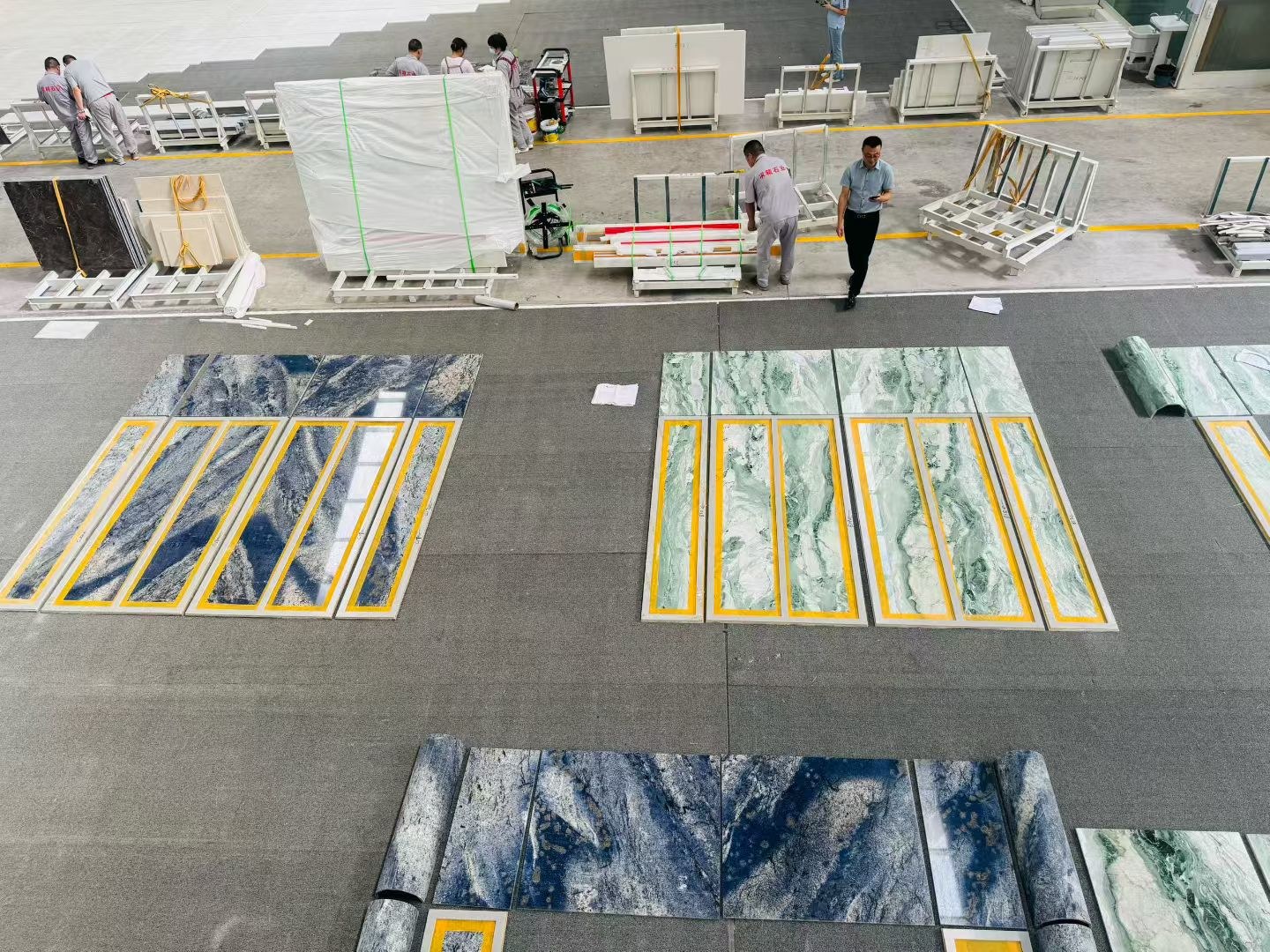 Different stone patterns laid out side by side on the factory floor for comparison