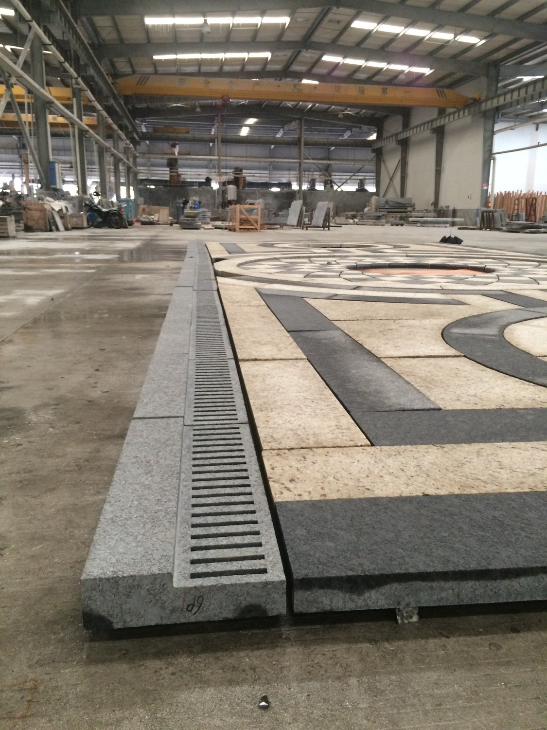 A granite border edge with an integrated stone-clad drainage channel