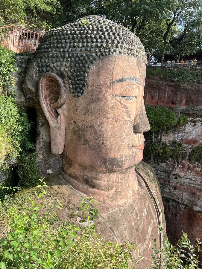 The Leshan Giant Buddha, a red sandstone statue carved into a cliff face in Sichuan, China