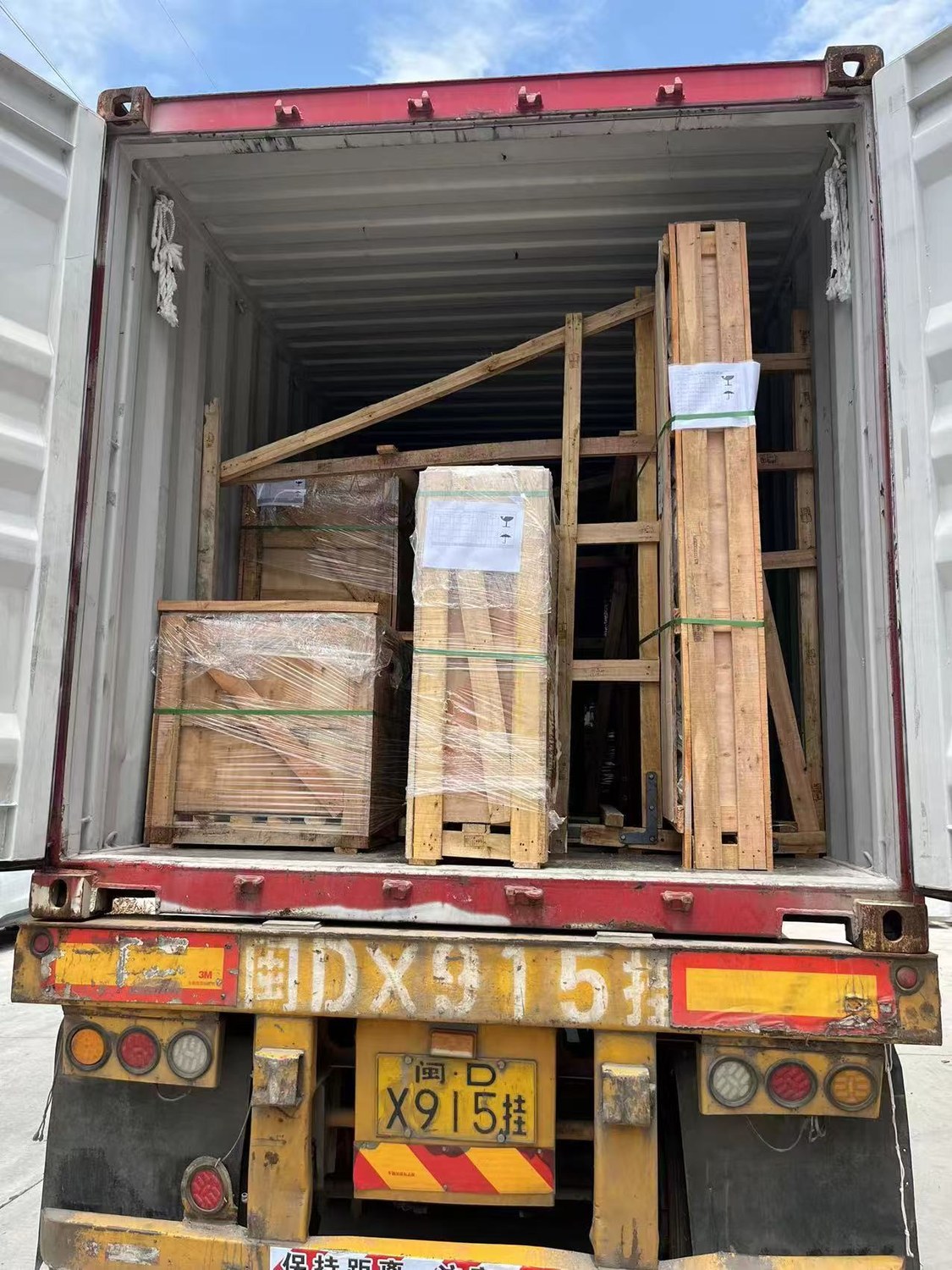 Wooden crates and A-frames loaded and secured inside a shipping container